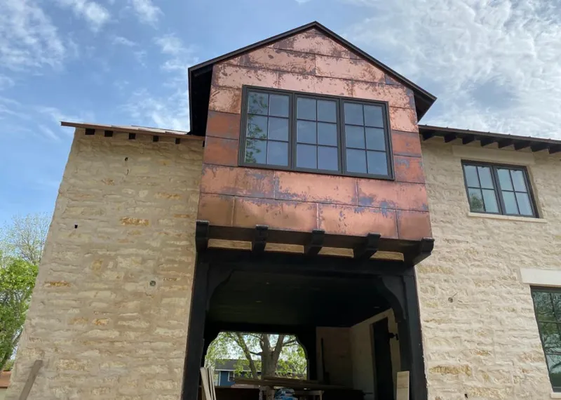 Copper metal panel facade on a stone building for Roof Repair in Woodland Park
